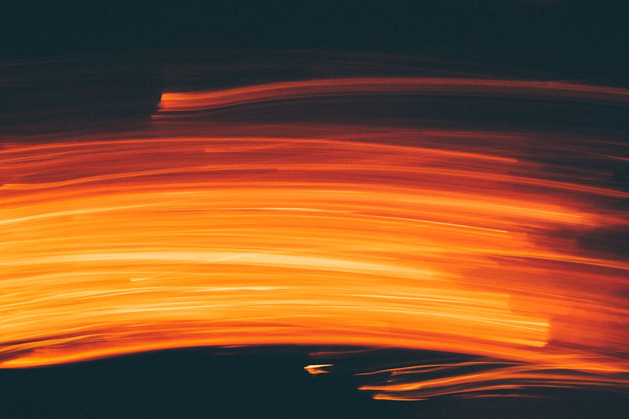 gallery-1 Dynamic abstract image of orange light streaks creating a vivid and bright pattern.